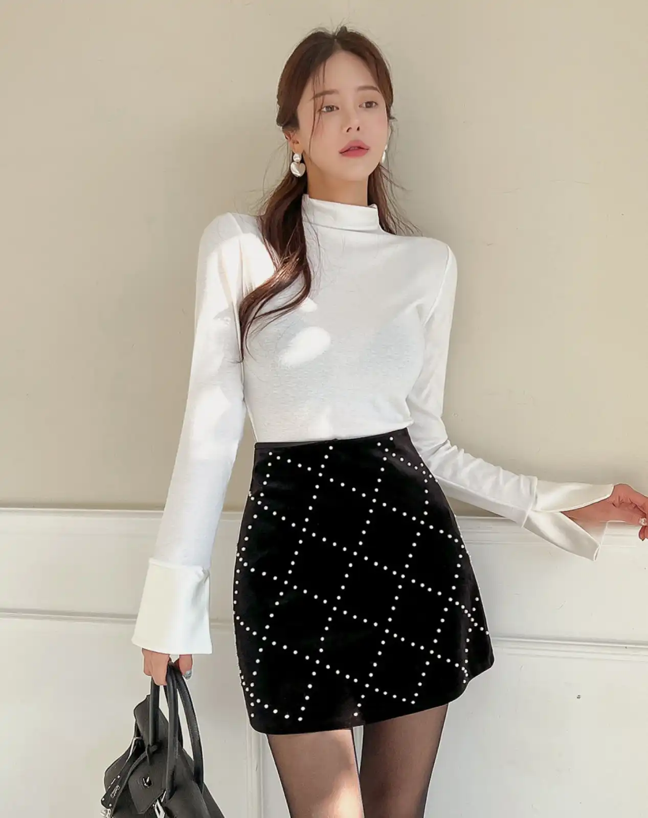 Pearl Mini with a White Turtleneck Main View
